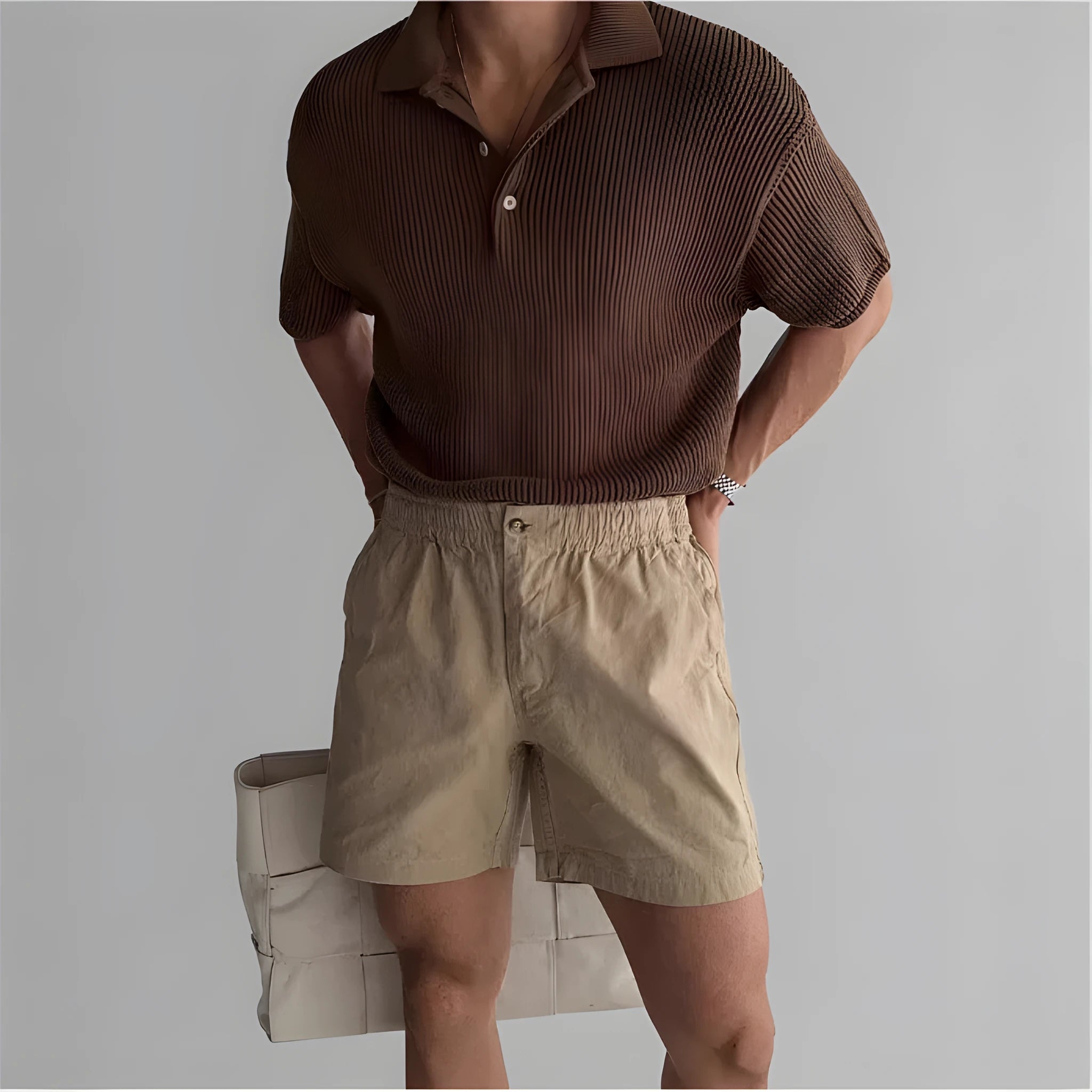 Man's loose-fit cotton sports shorts in black, showing elastic waistband with drawstring.