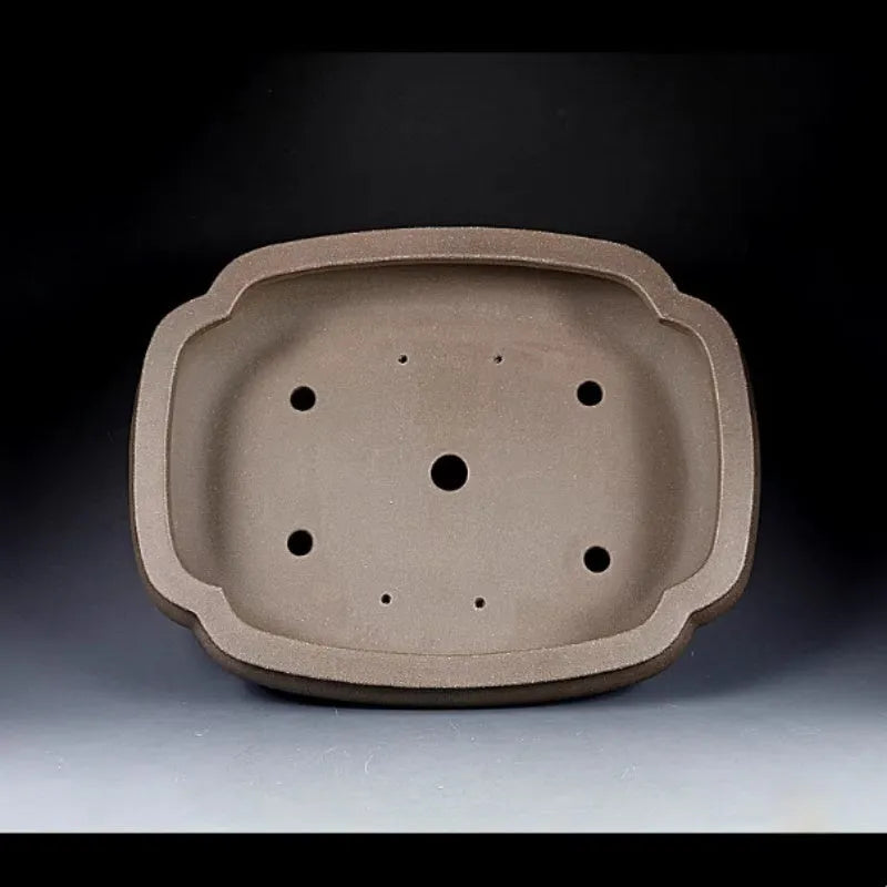 Handmade antique purple clay papaya-shaped flower pot shown from the side.