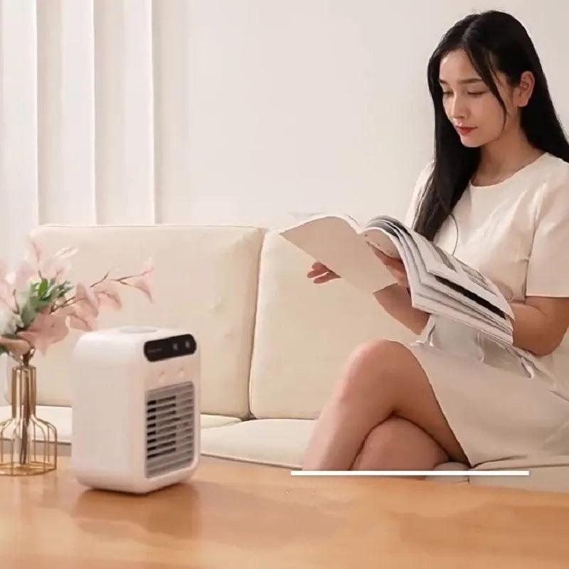 Ivory white portable USB air cooler fan with touchscreen panel on a desk