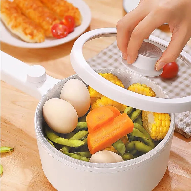 White and green multi-function electric cooking pot with temperature control dial and conversion plugs