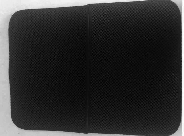 Waterproof EVA double-layer cat litter mat in black honeycomb design, size L foldable, placed under a litter box