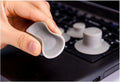 Four grey durable plastic laptop cooling pads, two large and two small, on a wooden desk.