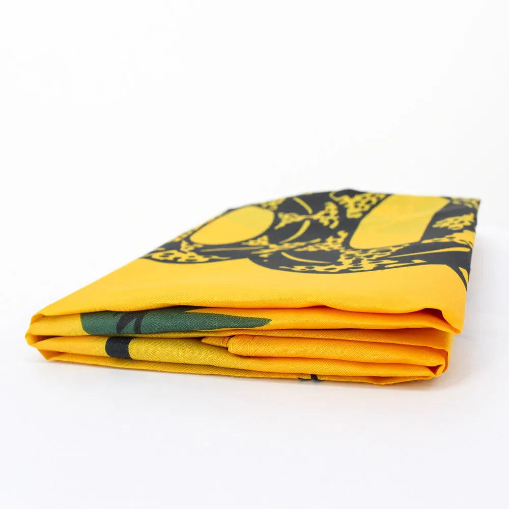 Yellow polyester garden flag with screen-printed design, 90 by 150 centimetres, hanging on a fence.