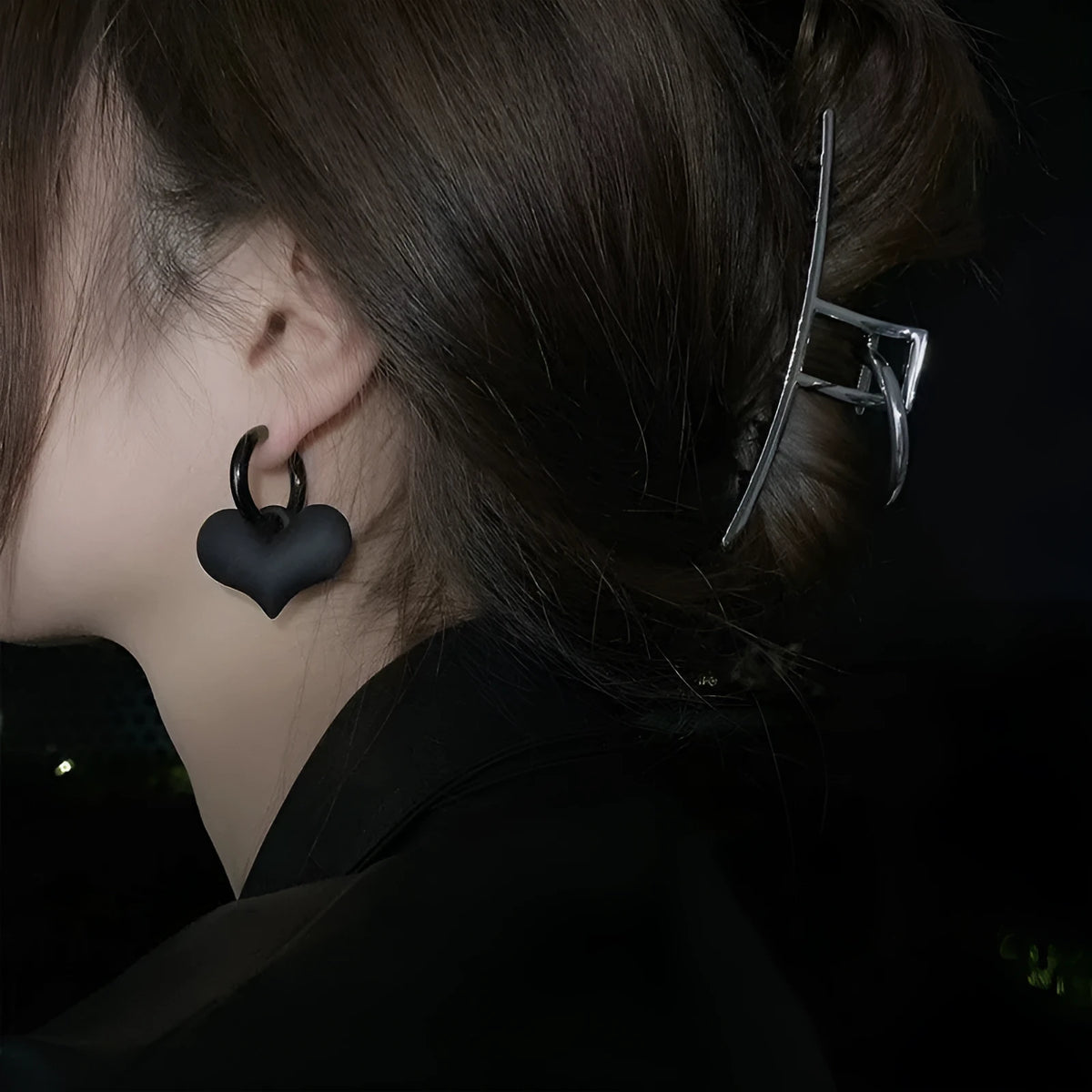 Black heart-shaped earrings with glass inlay in Korean style, shown as one pair