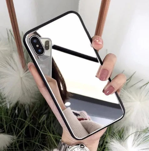 Black iPhone case with a reflective mirror panel on the back, shown fitted to an iPhone.