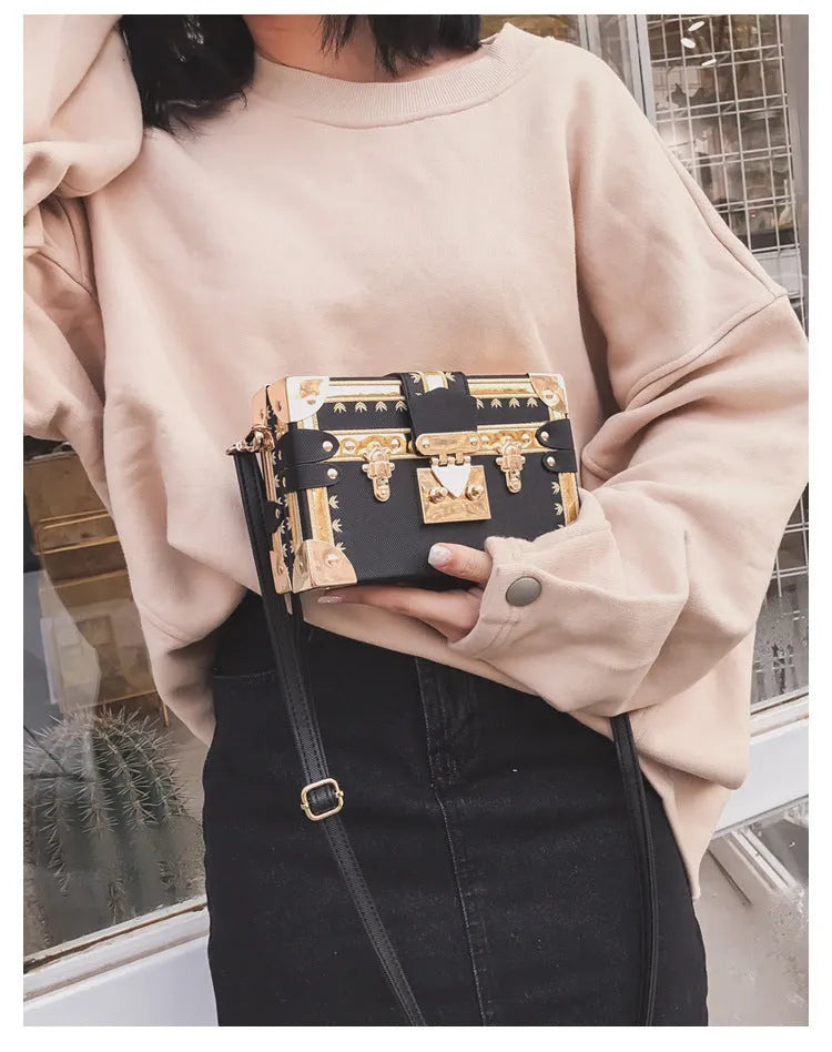 Women's black or green hard flap top shoulder bag made of PU leather with rivet details.