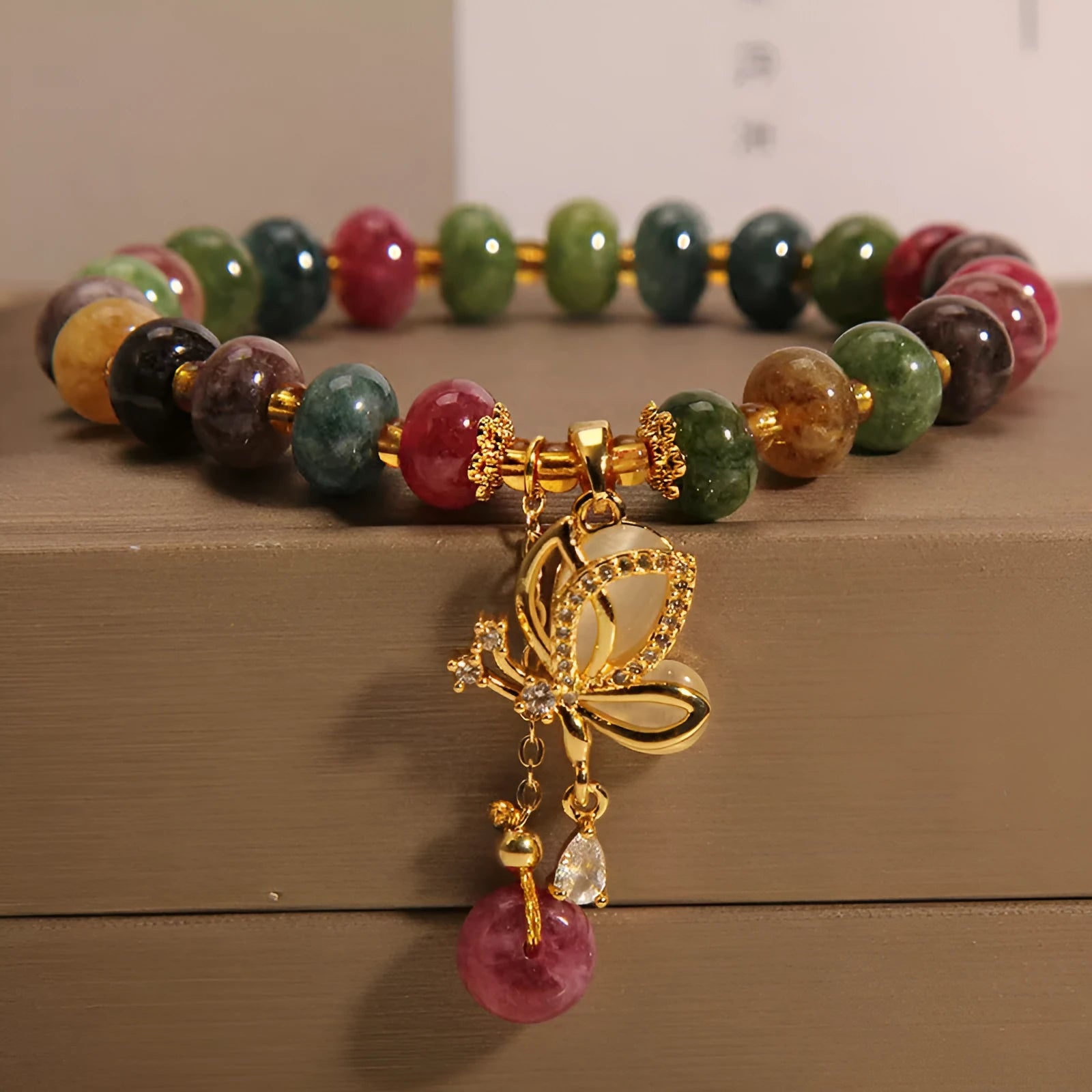 Colourful bead bracelet with alloy butterfly charm for women showing adjustable length