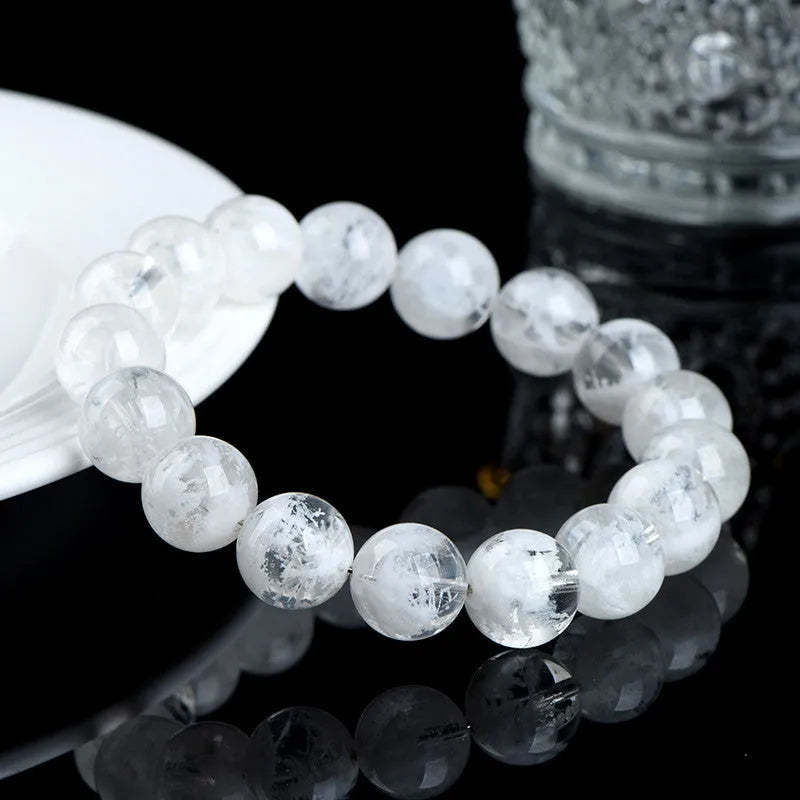 Women's bracelet with round blizzard snowflake crystal beads in geometric shapes on a wrist.