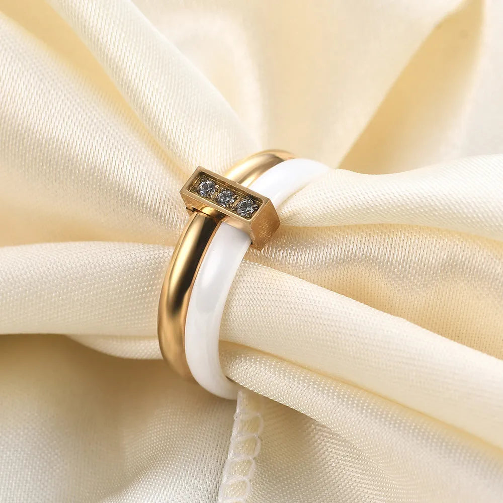 Glossy black geometric ceramic ring with a 6mm wide band on a woman's finger.