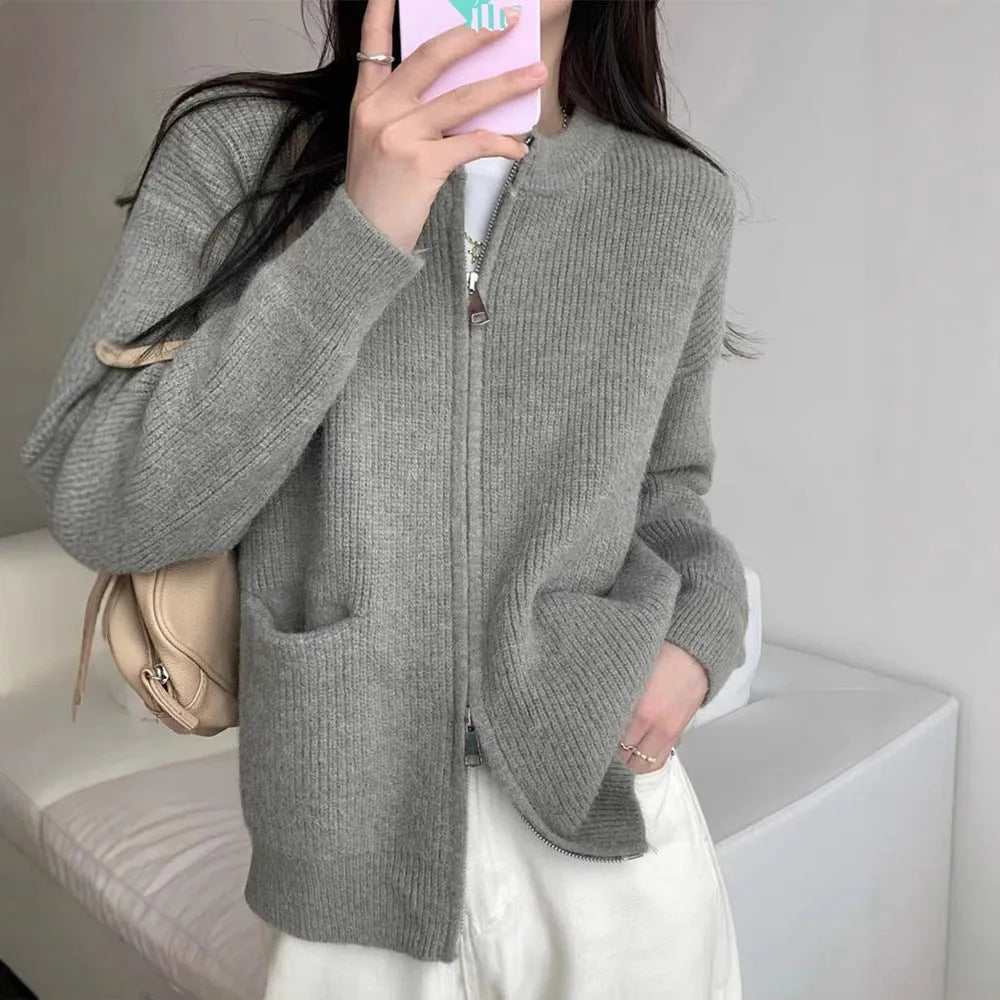 Beige viscose fibre sweater coat cardigan with long sleeves laid flat.
