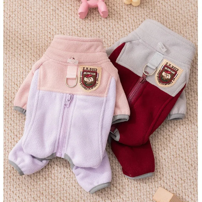 Four-legged fleece pet jacket in colour block design with full zipper and badge patch, sizes S-XXL for cats and small dogs.