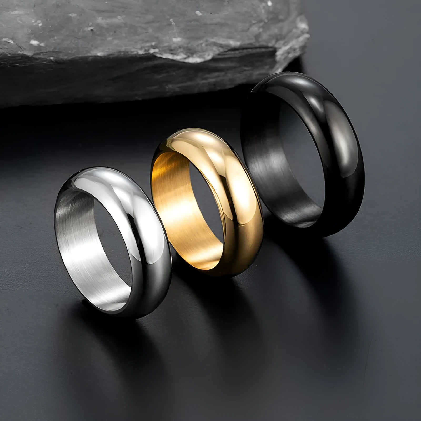Glossy electroplated titanium steel ring shown in gold, black, and steel colour on a plain background.