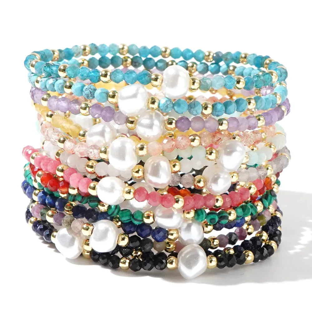 A unisex natural stone bracelet with elliptical geometric beads on a wrist, shown in one of the multiple available colours.