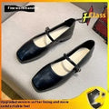 Women's black sheepskin Mary Jane flat shoes with round toe and flat rubber sole on a white background.