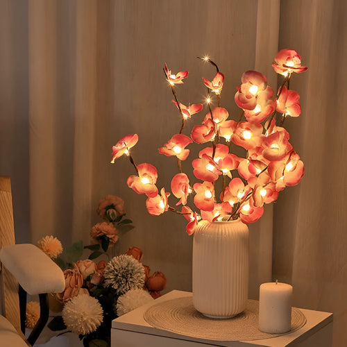 A 65cm tall pink LED phalaenopsis orchid branch light with fabric petals, powered by batteries.