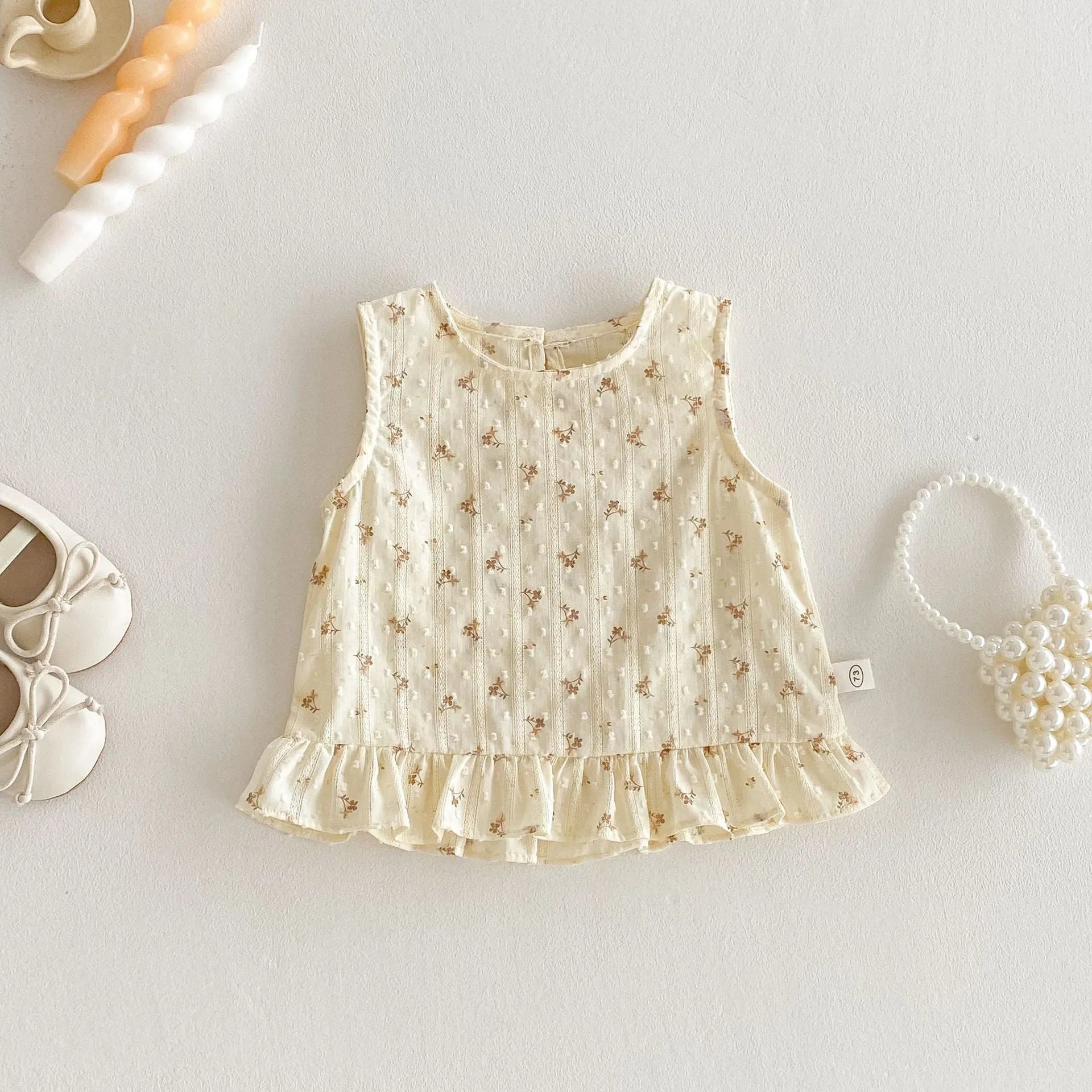 Children's cotton sleeveless top and trousers two-piece set in cream apricot on white background