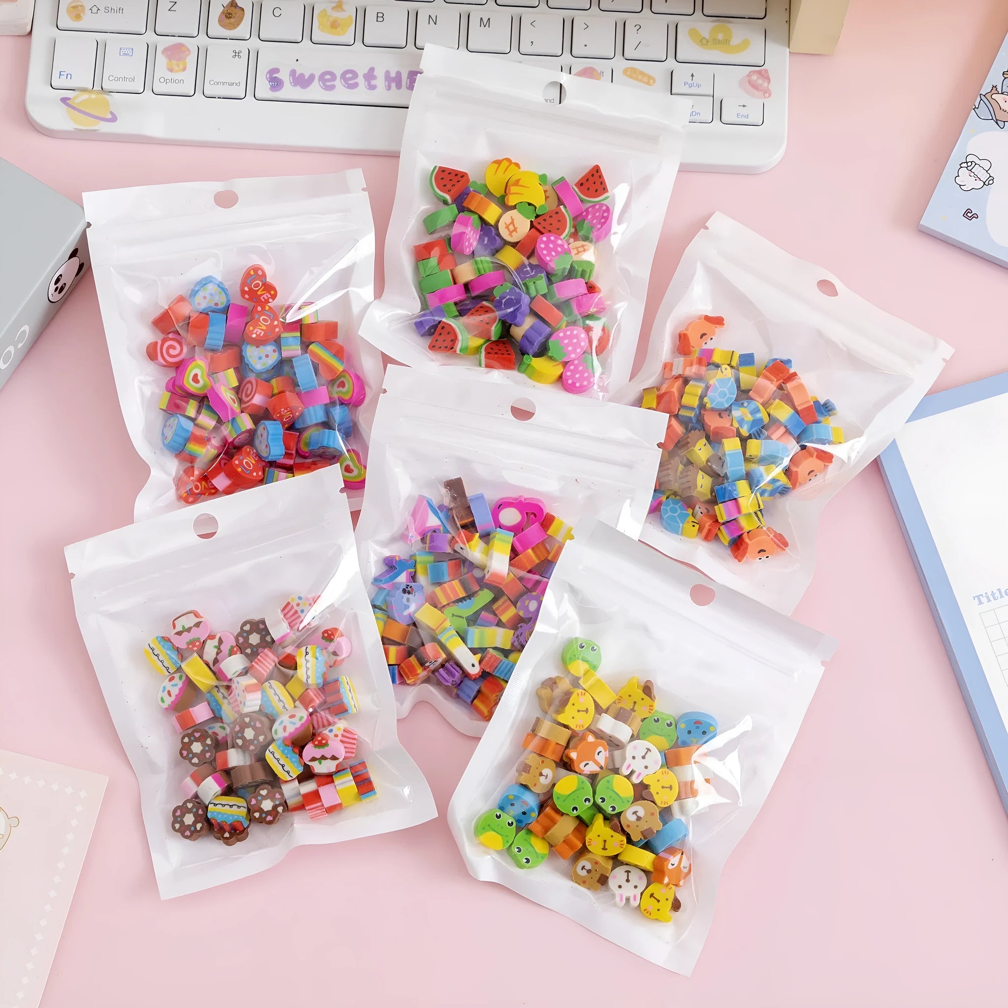 50 small colourful cartoon-themed TPR rubber erasers in a pearlescent film bag