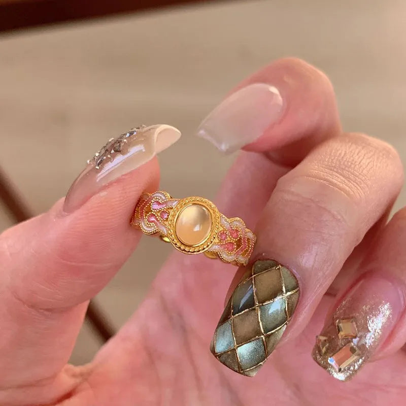 Open mouth geometric ring with pink crystal enamel accents on gold-plated copper band