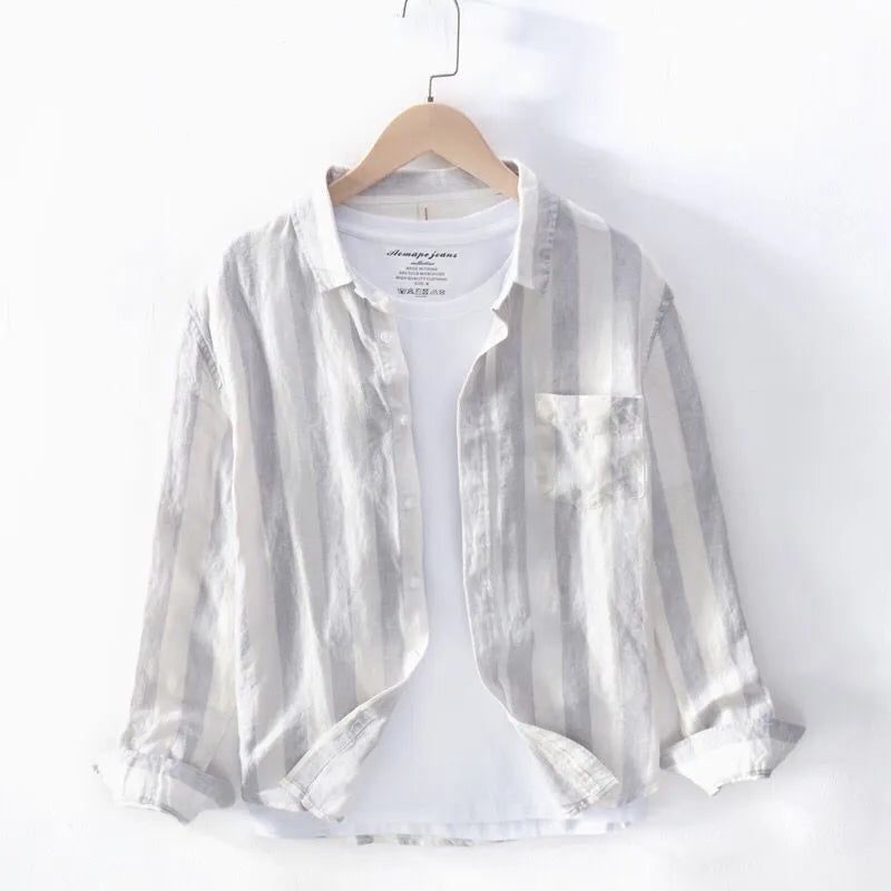 Blue long sleeve Hong Kong style loose fit men's casual shirt on a hanger.