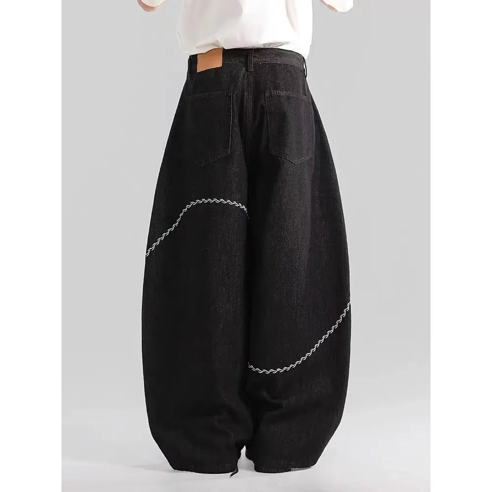 Black men's straight-leg denim trousers with a mid-rise waist and zip fly.