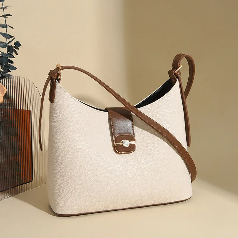 Black PU bucket bag with a single shoulder strap, showing contrast stitching and a lock detail.