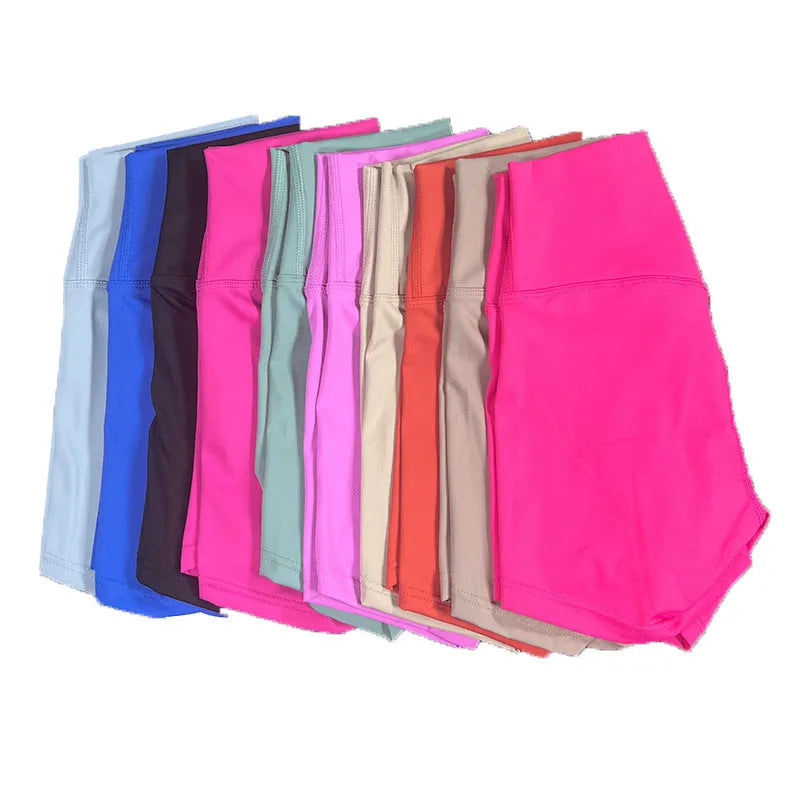 High-waisted women's yoga shorts in nylon fabric, shown in a selection of colours including pink litchi and cayenne red.