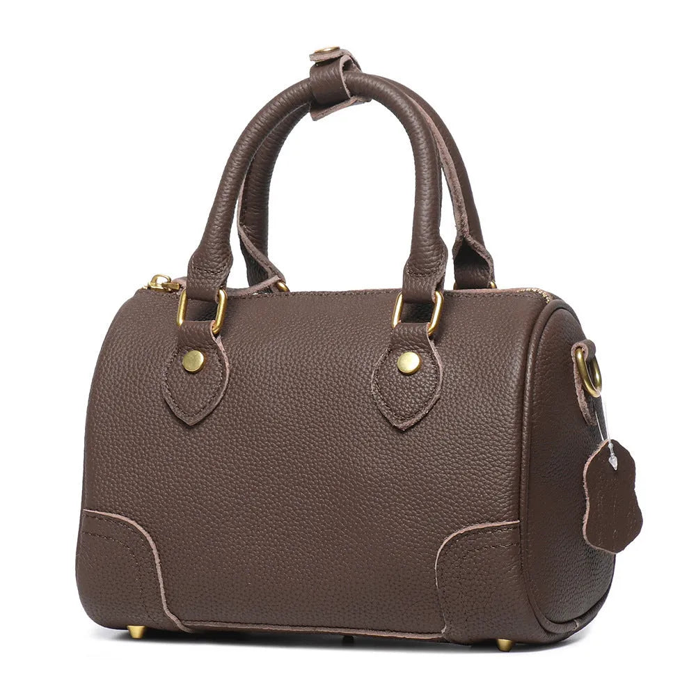 Brown handmade cowhide leather Boston bag with cylindrical shape and single shoulder strap