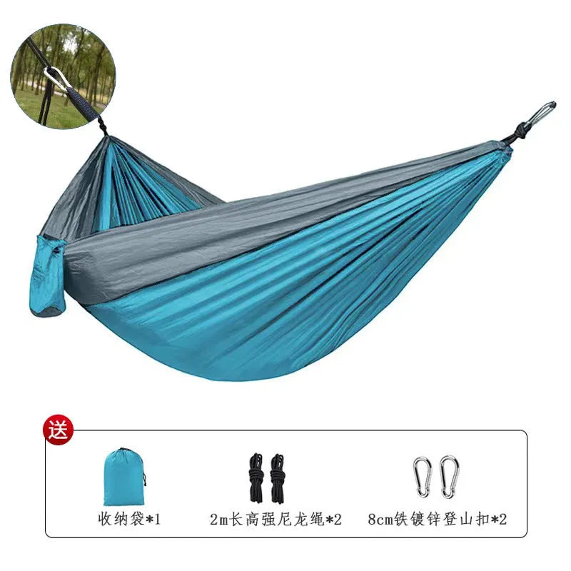 A sapphire blue double-layer nylon hammock hung between two trees, showing its full 270cm length and 140cm width.