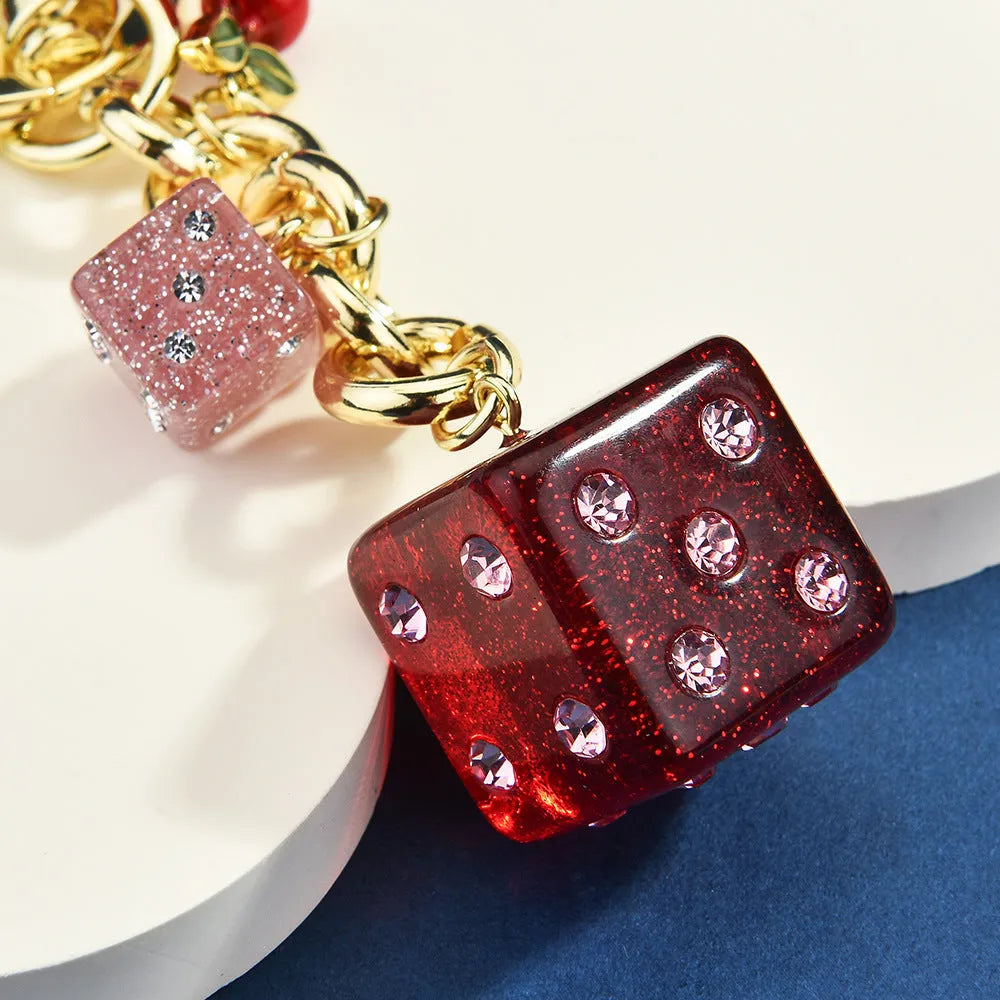 Square cherry red and silver dice pattern metal keychain pendant on a key ring