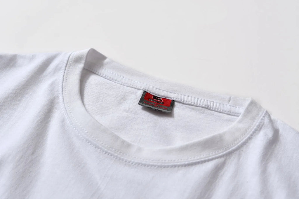 White cotton t-shirt overalls with short sleeves and a loose pullover fit