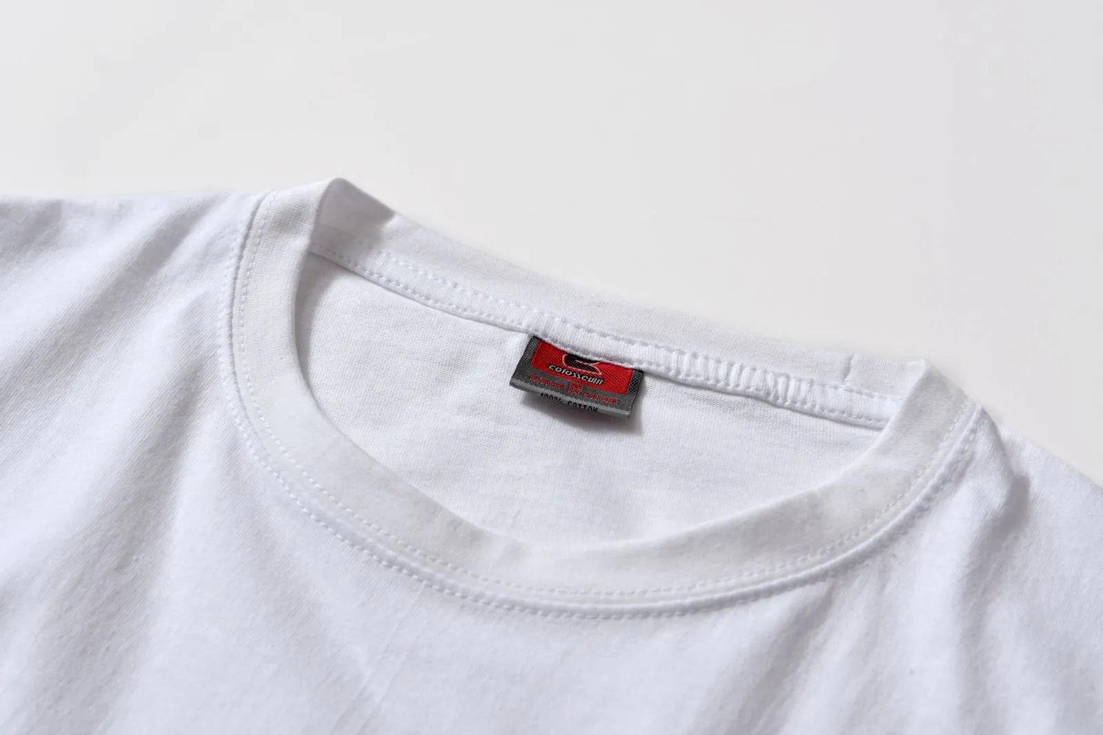 White cotton t-shirt overalls with short sleeves and a loose pullover fit