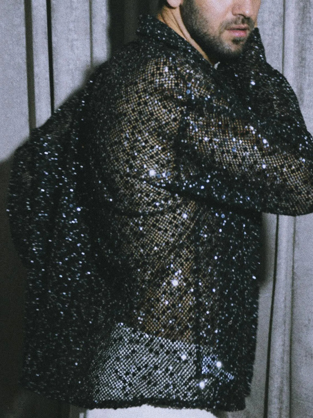 Black sequin sheer open-front shirt with oversized silhouette on display
