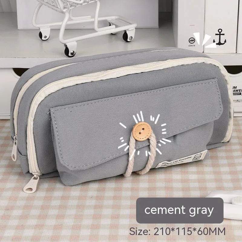 Green canvas pencil case with button closure, large capacity for pens.