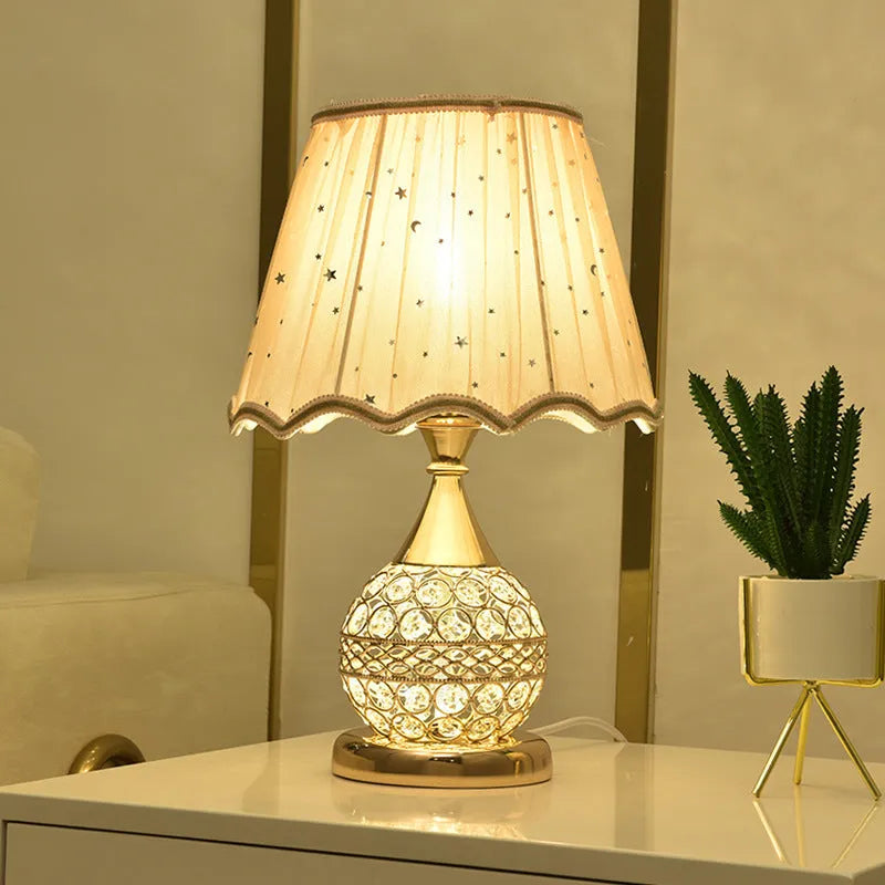 Gold crystal desk lamp with hand-finished pendant and iron art base on wooden surface