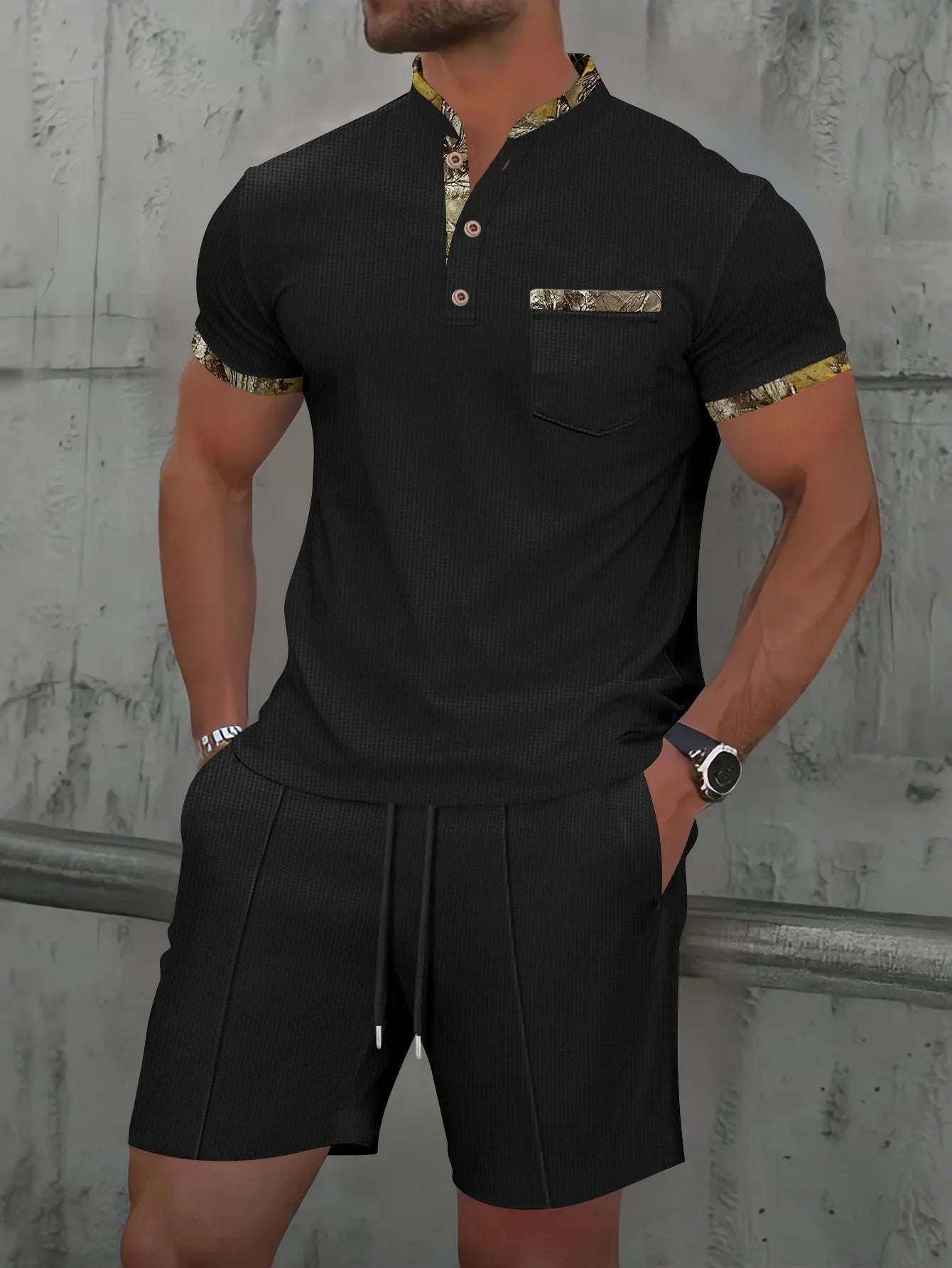 Man modelling a grey zip-front polo collar top and matching shorts, a waffle knit leisure suit set.