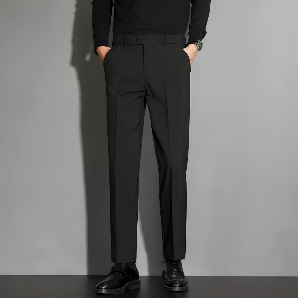 Men's straight-leg ankle-length suit trousers in a light colour, showing the spring draping effect on the leg.