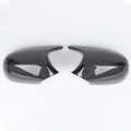 A pair of black ABS plastic rearview mirror shells for a BMW 3 Series E90 car.