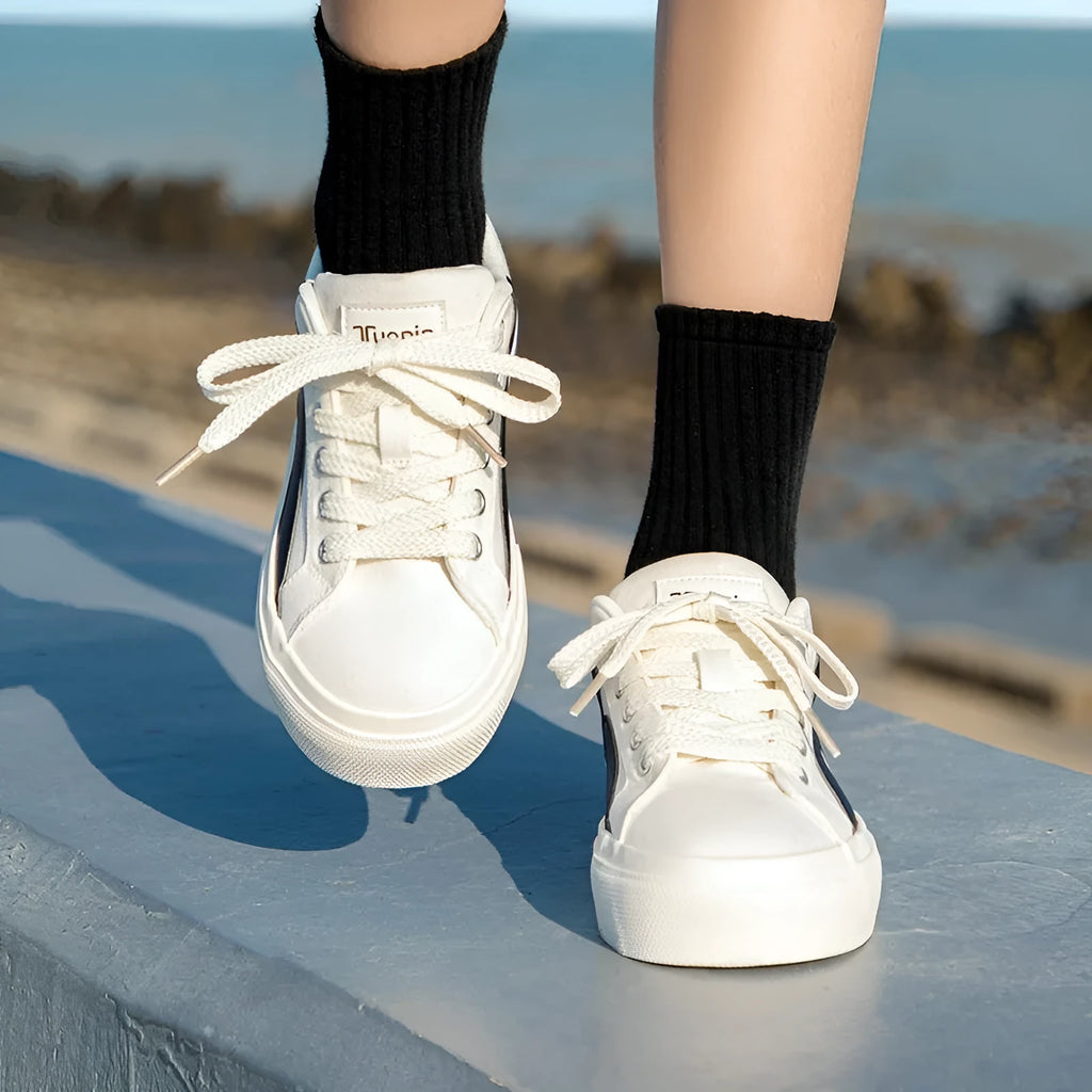 Minority women's low top board shoes in black and white colourway, synthetic leather upper, round toe.