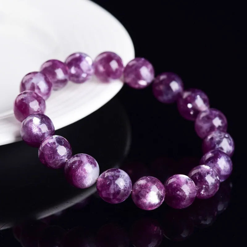 Grandmother crystal bracelet with polished purple geometry beads on a white background.