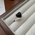 Black agate heart ring in sterling silver with an adjustable open mouth design.