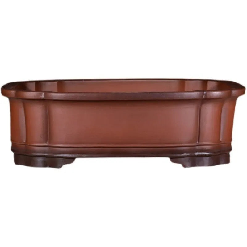 Large antique-style Chinese purple clay flowerpot with tree stump and floral relief pattern.
