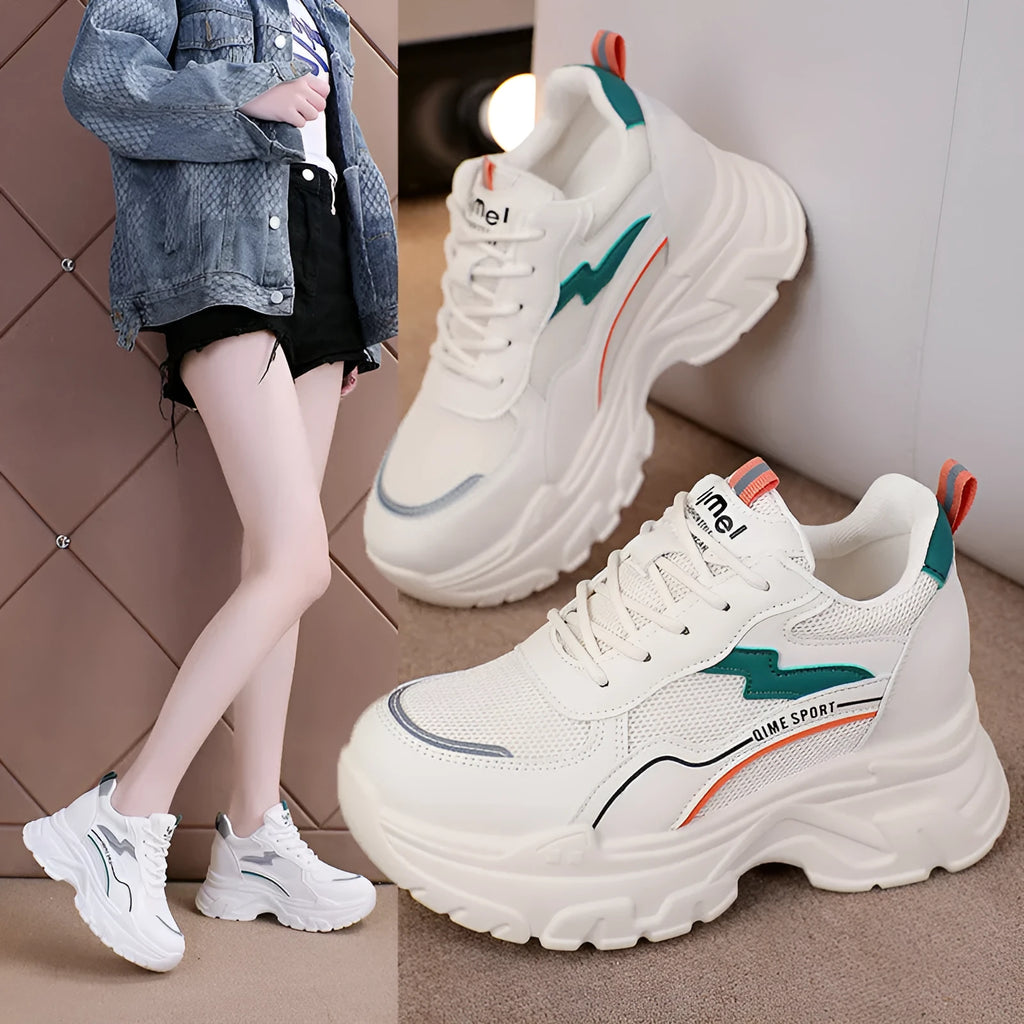 Women's white breathable dad shoes with cross strap and lace-up front on a rubber sole.