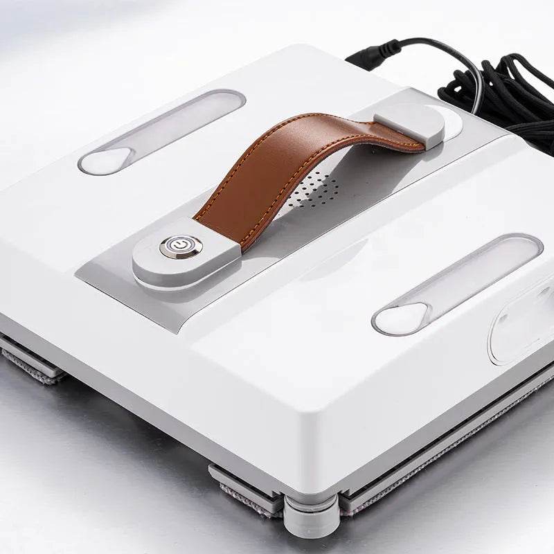 White intelligent window cleaning robot for high-rise buildings on a window pane.