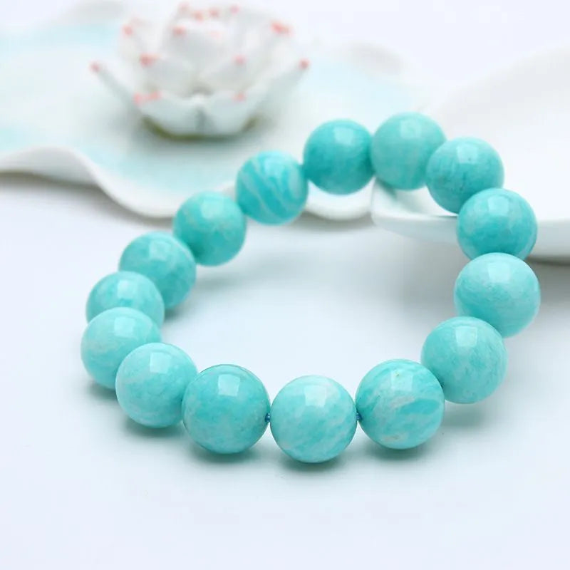 Natural blue-green Amazonite gemstone bracelet with adjustable closure on a wrist.