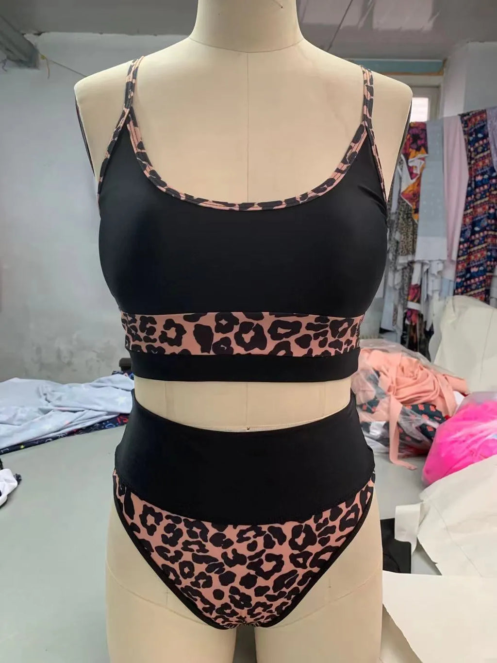 Women's white and leopard print high waist bikini swimsuit set on a mannequin.