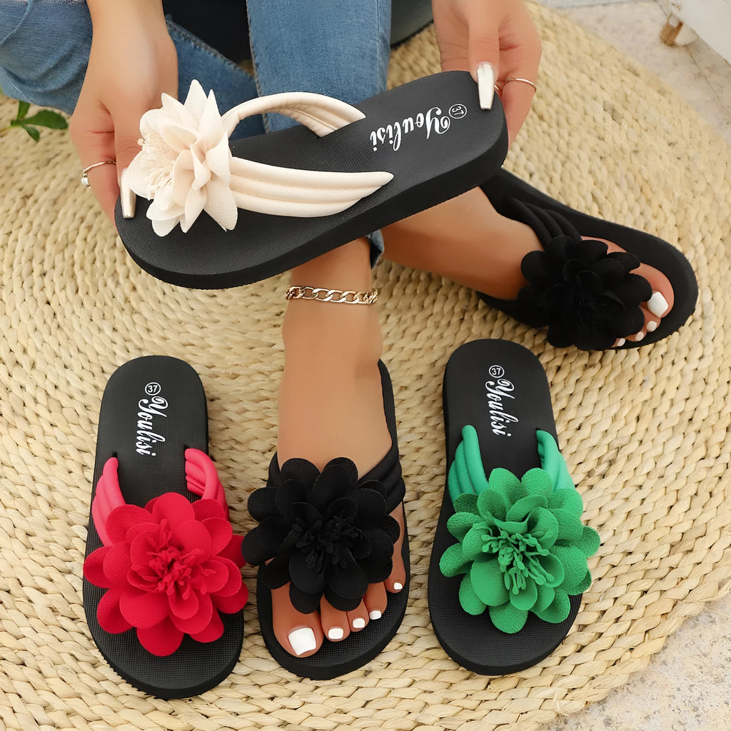 Women's beige flip-flops with a red flower decoration on the strap and a lightweight EVA sole.