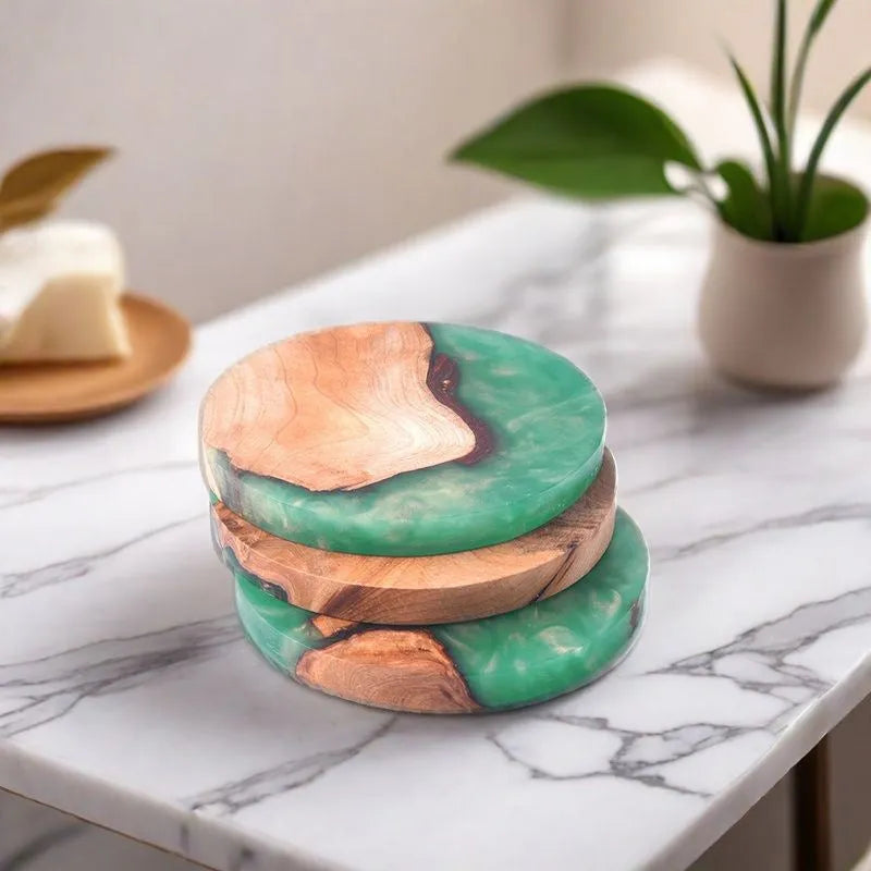 A solid black round resin coaster for a tea set, 9.8cm across and 1cm thick, on a wooden surface.