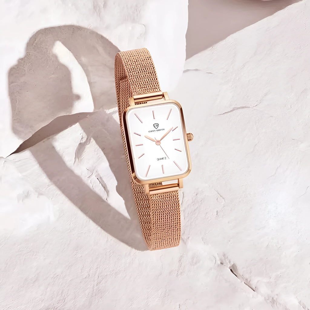 Rose gold women's quartz watch with woven steel strap on wrist, showing alloy case.