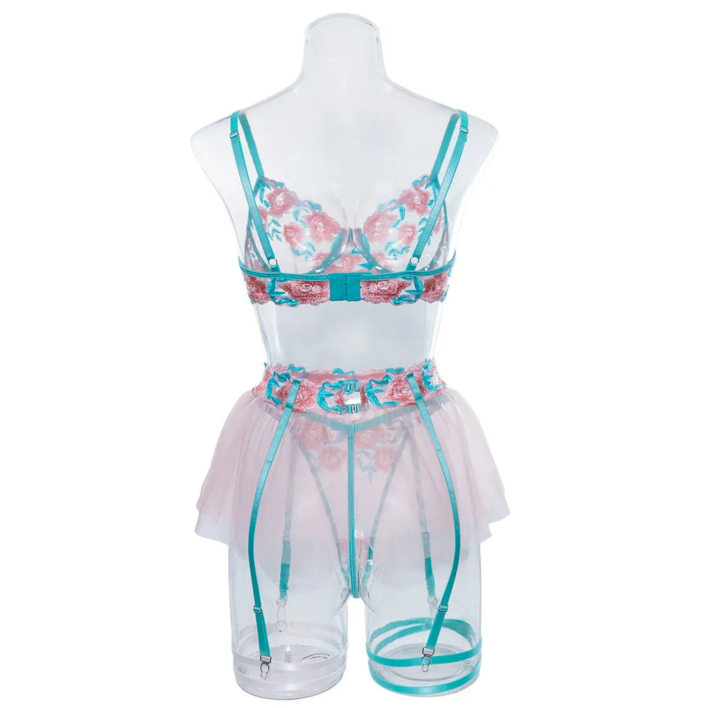 Pink women's bikini set with embroidered mesh pettiskirt and matching strappy top.
