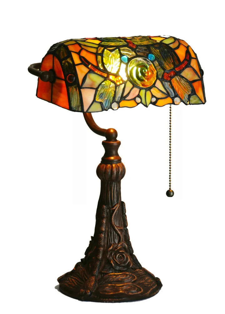 A 10-inch tall Tiffany-style table lamp with a stained glass shade on a resin base, shown on a desk.